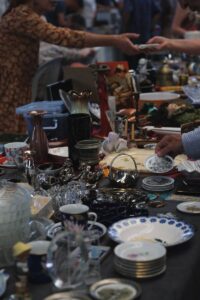 Discover unique items and antiques at a lively flea market tabletop display.
